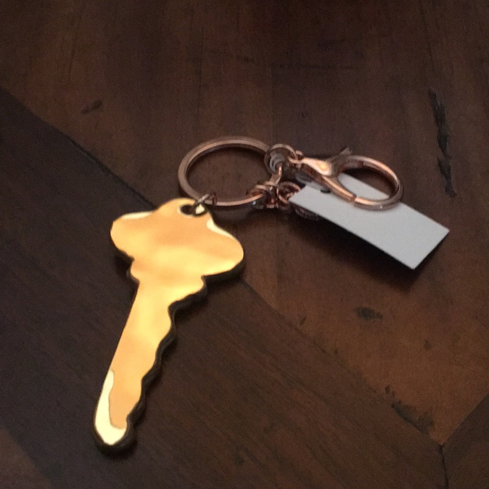 Anthropologie gold leather keychain . NWT